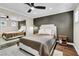 Modern bedroom with gray accent wall, wood floor, ceiling fan, and mirrored closet at 108 Quail Run Rd, Henderson, NV 89014