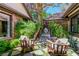 Relaxing courtyard featuring a lion fountain, chairs, and lush greenery at 108 Quail Run Rd, Henderson, NV 89014