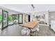 Sunlit dining room featuring a wooden table, clear chairs, and access to a private garden at 108 Quail Run Rd, Henderson, NV 89014
