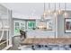 Open concept dining room features modern lighting, clear chairs, and an adjacent modern kitchen at 108 Quail Run Rd, Henderson, NV 89014