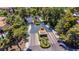 Aerial shot of a secure gated community entrance with landscaped median and surrounding trees at 108 Quail Run Rd, Henderson, NV 89014