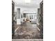 Elegant foyer with marble flooring and decorative iron doors leading to a bright and spacious living area at 108 Quail Run Rd, Henderson, NV 89014