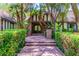 Beautiful home with manicured hedges, mature trees, and a brick walkway leading to the front entrance at 108 Quail Run Rd, Henderson, NV 89014