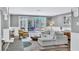 Bright living room with wood floors, white wainscoting, and french doors to backyard patio at 108 Quail Run Rd, Henderson, NV 89014