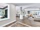 Bright living room with wood floors, gray accent walls, fireplace, and direct access to a courtyard at 108 Quail Run Rd, Henderson, NV 89014