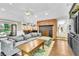 Bright living room with a fireplace, bar, and access to the outdoors; perfect for entertaining at 108 Quail Run Rd, Henderson, NV 89014