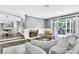 Bright living room featuring a fireplace, access to the dining room, and backyard views at 108 Quail Run Rd, Henderson, NV 89014