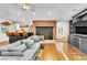 Open-concept living room featuring fireplace, a bar, comfortable seating and hardwood floors at 108 Quail Run Rd, Henderson, NV 89014