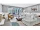 Cozy living room features gray walls, wainscoting, modern decor, and backyard access through French doors at 108 Quail Run Rd, Henderson, NV 89014