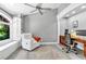 Bright office space with a window view, comfortable seating, and a functional workspace with wooden desk and shelves at 108 Quail Run Rd, Henderson, NV 89014
