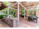 Outdoor kitchen area with a built-in grill, dining area, seating, and a covered patio for outdoor entertaining at 108 Quail Run Rd, Henderson, NV 89014