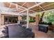 Inviting outdoor living space with a dining table, seating area, and a stylish corrugated metal roof for shade at 108 Quail Run Rd, Henderson, NV 89014