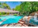 A backyard pool with a diving board and integrated fountain feature surrounded by lush landscaping at 108 Quail Run Rd, Henderson, NV 89014