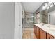 Bathroom with double sinks, glass shower, and neutral tile and cabinets at 1150 Red Margin Ct # 101, Las Vegas, NV 89183