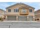Exterior shot of the townhome shows the attached two-car garage and private balcony at 1150 Red Margin Ct # 101, Las Vegas, NV 89183