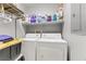Functional laundry room with washer, dryer, and storage shelves at 1150 Red Margin Ct # 101, Las Vegas, NV 89183