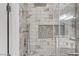 Modern shower with marble-style tile, pebble accent wall, and sleek glass enclosure at 1150 Red Margin Ct # 101, Las Vegas, NV 89183
