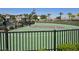 Community basketball court with green playing surface, basketball hoop, and black surrounding fence at 12348 Golden Wreath Rd # 1, Las Vegas, NV 89183