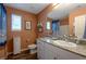 Bathroom featuring granite countertop, a vanity, coastal decor and a tub/shower at 12348 Golden Wreath Rd # 1, Las Vegas, NV 89183