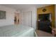 Cozy bedroom with neutral carpet, accent wall, sliding closet doors and a large television at 12348 Golden Wreath Rd # 1, Las Vegas, NV 89183