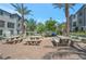 Outdoor area with concrete picnic tables, desert landscaping, and palm trees creating a lovely space for residents to enjoy at 12348 Golden Wreath Rd # 1, Las Vegas, NV 89183