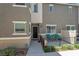 Modern townhouse with a private patio area, black fence, and well-maintained landscaping at 12348 Golden Wreath Rd # 1, Las Vegas, NV 89183