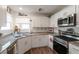 Charming kitchen featuring white cabinets, granite countertops, and modern stainless steel appliances at 12348 Golden Wreath Rd # 1, Las Vegas, NV 89183