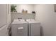 Functional laundry room with modern appliances and a shelf for storage at 12348 Golden Wreath Rd # 1, Las Vegas, NV 89183