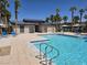 Community pool with clear blue water, a bathhouse, lounge chairs and palm trees at 12348 Golden Wreath Rd # 1, Las Vegas, NV 89183
