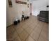 Living room with tiled floors, gray sofa, decorative table, and accent plants at 1405 Vegas Valley Dr # 378, Las Vegas, NV 89169