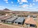 An aerial view shows the house with a well manicured backyard, neighborhood and mountain views at 171 Palm Fox Ct, Henderson, NV 89011
