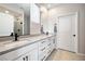 Elegant bathroom with dual sinks, white cabinets, and modern fixtures at 171 Palm Fox Ct, Henderson, NV 89011