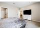 Well-lit bedroom with a TV, double doors, and carpeted floors at 171 Palm Fox Ct, Henderson, NV 89011
