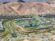 Bird's eye view of a desert community with swimming pools, mature landscaping, and winding sidewalks at 171 Palm Fox Ct, Henderson, NV 89011