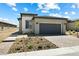 Landscaped front yard featuring a modern home with stone accents and neutral colors at 171 Palm Fox Ct, Henderson, NV 89011