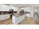 Bright kitchen features white cabinets, stainless steel appliances, a center island, and modern finishes at 171 Palm Fox Ct, Henderson, NV 89011