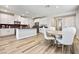 Modern kitchen and dining area with white cabinets and stainless steel appliances at 171 Palm Fox Ct, Henderson, NV 89011