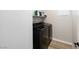 Laundry room equipped with black washer and dryer units and a shelf at 171 Palm Fox Ct, Henderson, NV 89011