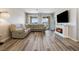 Cozy living room featuring a sectional sofa, electric fireplace, and access to an outdoor patio at 171 Palm Fox Ct, Henderson, NV 89011