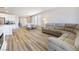 Open-concept living room featuring dining area, kitchen, and large sectional sofa at 171 Palm Fox Ct, Henderson, NV 89011