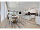 Open-concept living area with wood floors, kitchen, and dining space at 171 Palm Fox Ct, Henderson, NV 89011