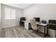 Bright home office featuring wood floors, two work stations, and a window for natural light at 171 Palm Fox Ct, Henderson, NV 89011