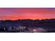 Beautiful sunset view of the community highlighting manicured landscaping and community streets at 171 Palm Fox Ct, Henderson, NV 89011