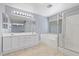 Bright bathroom featuring a double vanity, soaking tub, and glass-enclosed shower at 180 Duck Hollow Ave, Las Vegas, NV 89148