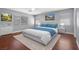 Charming bedroom featuring wood floors, large windows, and modern decor at 180 Duck Hollow Ave, Las Vegas, NV 89148
