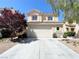 Charming two-story home features a two-car garage, well-maintained landscaping, and a welcoming facade at 180 Duck Hollow Ave, Las Vegas, NV 89148