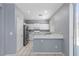 Bright kitchen featuring white cabinets and quartz countertops at 180 Duck Hollow Ave, Las Vegas, NV 89148