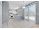 Sunlit kitchen featuring a breakfast bar and access to backyard at 180 Duck Hollow Ave, Las Vegas, NV 89148