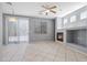 Bright and airy living room with a fireplace, sliding glass doors, and tile floors at 180 Duck Hollow Ave, Las Vegas, NV 89148