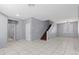 Bright living room features white tiled flooring and staircase at 180 Duck Hollow Ave, Las Vegas, NV 89148